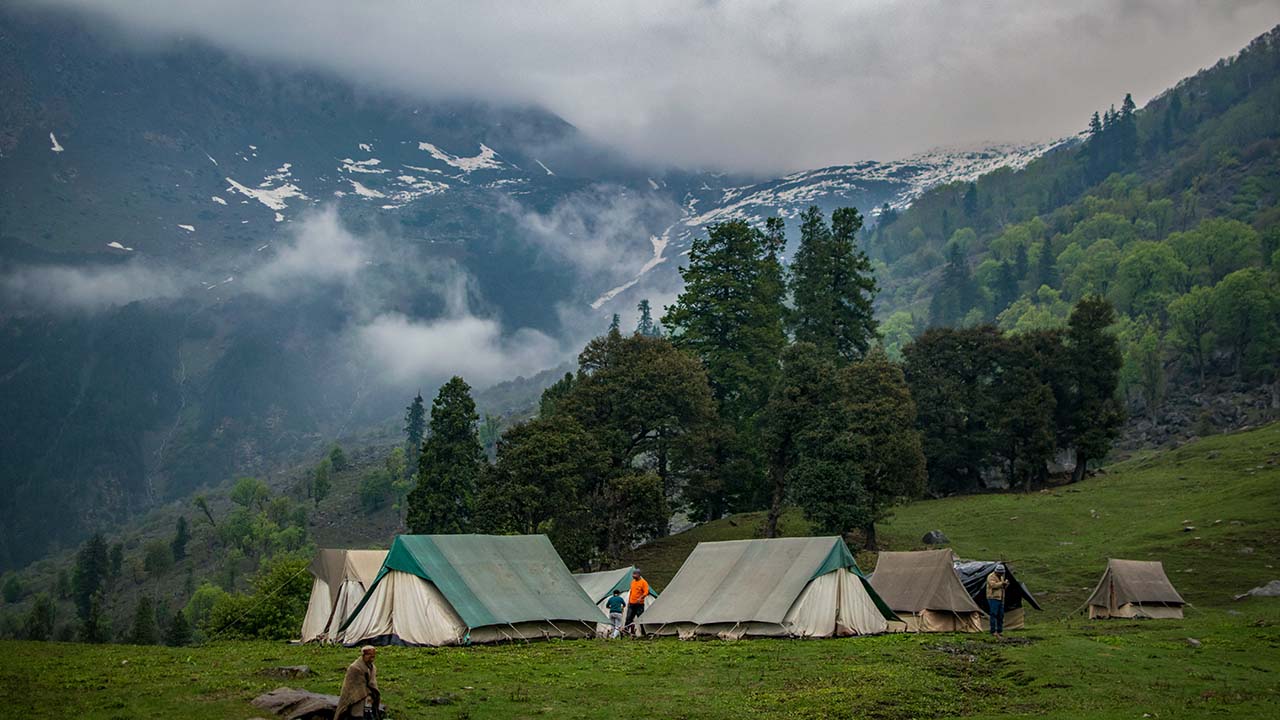 A mountain camping with clouds and fog